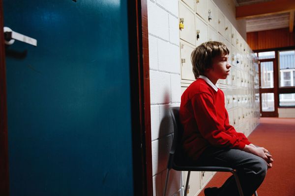001 - BOR Intro - Getty Student sitting in hallway on chair time out