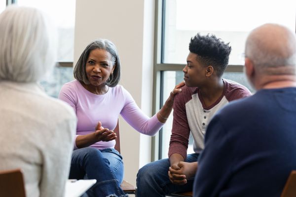Older couple talking with teacher and student in a circle